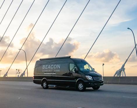 beacon van on road at sunrise