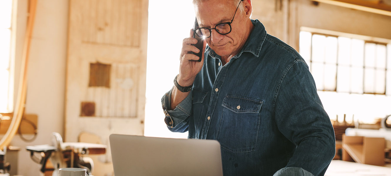 Man on phone and computer