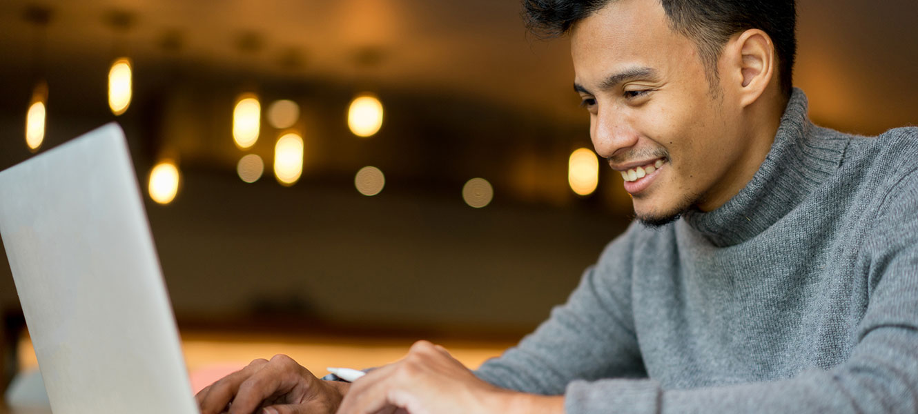 Man using computer in coffee shop