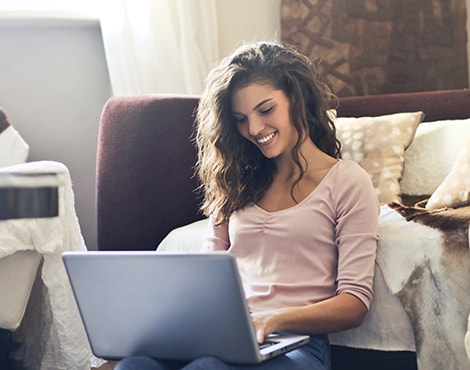 Young woman using laptop in living room