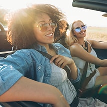 Young friends driving car